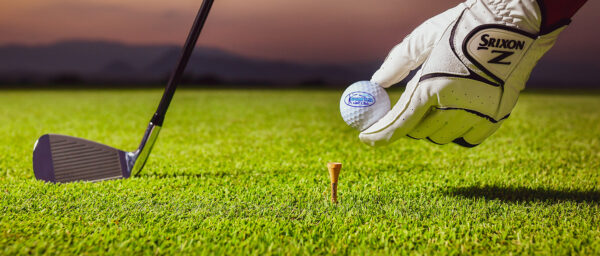 Golfholder golfbold i hånden på Grand Prix Golf Club, Kanchanaburi