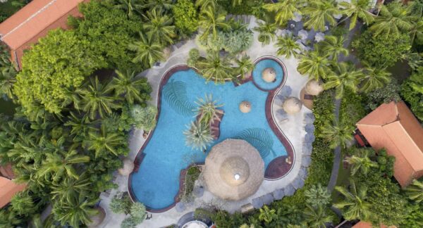 Udsigt ovenfra af Anantara Hua Hin Resorts swimmingpool omgivet af frodige grønne områder