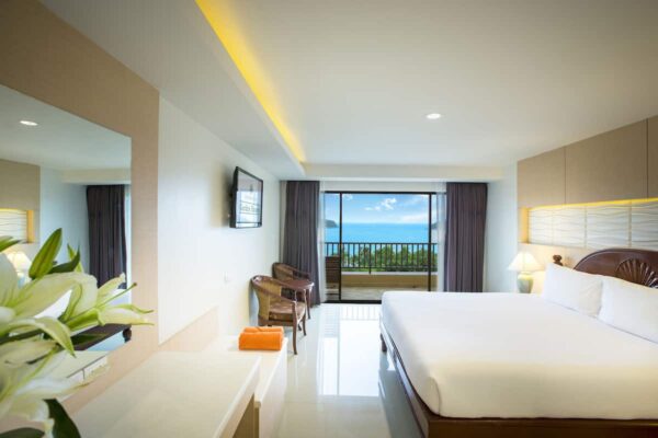 Hotelværelse med stor seng og havudsigt på Chanalai Garden Resort