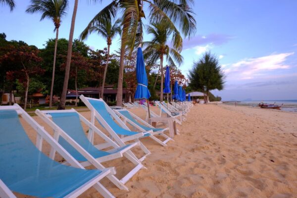 Fantasy Resort Koh Hai Beach Lounge Chairs, Palm Trees Surroundings.