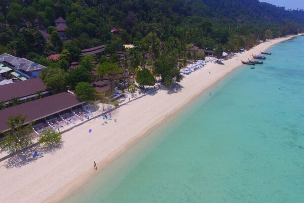 Overhead-udsigt over stranden ved Koh Hai Fantasy Resort i Thailand, der viser klart vand, hvid sandstribe og resort-overnatningssteder