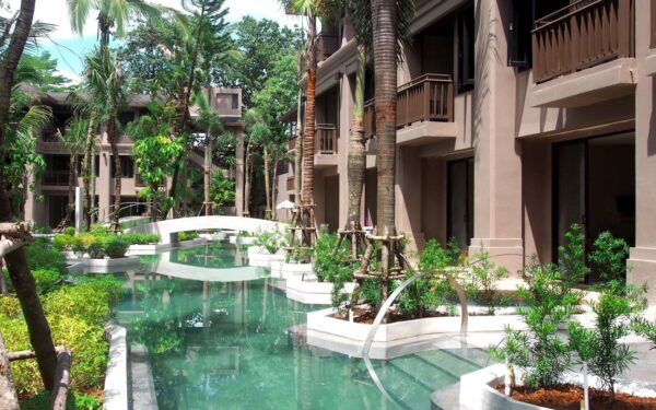 Khao Lak's La Flora Resort fremviser en fredelig pool omgivet af tropiske palmer. Oplev ro og afslapning i denne uberørte oase for gæster.